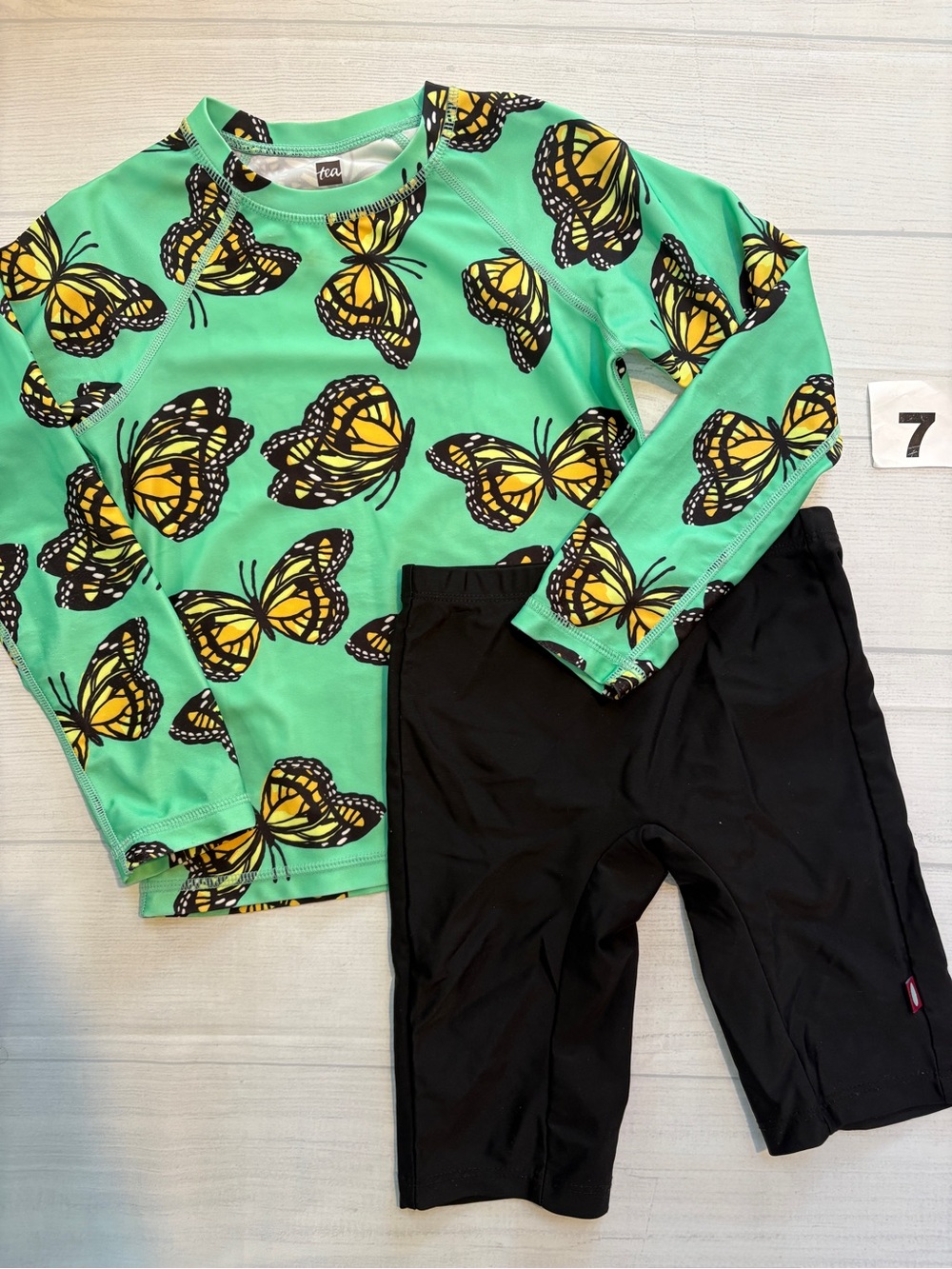 Tea Collection Kids Green Butterfly Rashguard Top with Black Swim Shorts